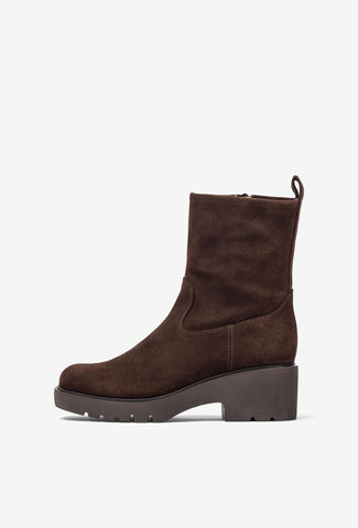 Brown suede boot on a white background