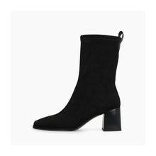 Load image into Gallery viewer, A black suede ankle boot with a chunky block heel and a pull tab at the back collar, shown in profile against a light gray background.
