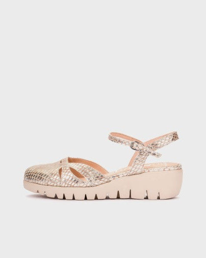gold sandal with a platform sole on a light gray background