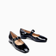 Load image into Gallery viewer, A pair of black patent leather Mary Jane shoes with low block heels and buckle straps, displayed on a clean white background.
