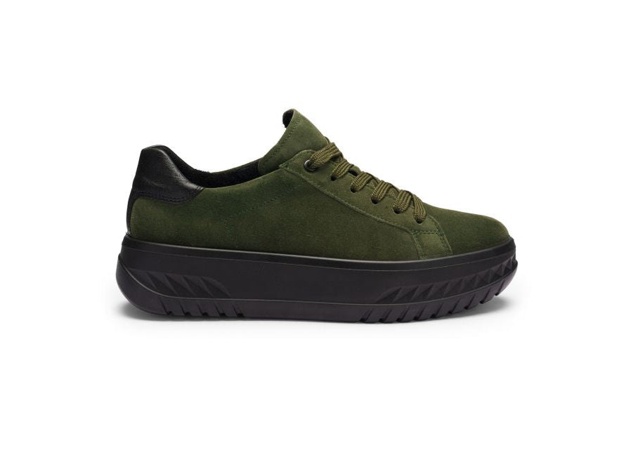 Green sneaker with black sole on a white background