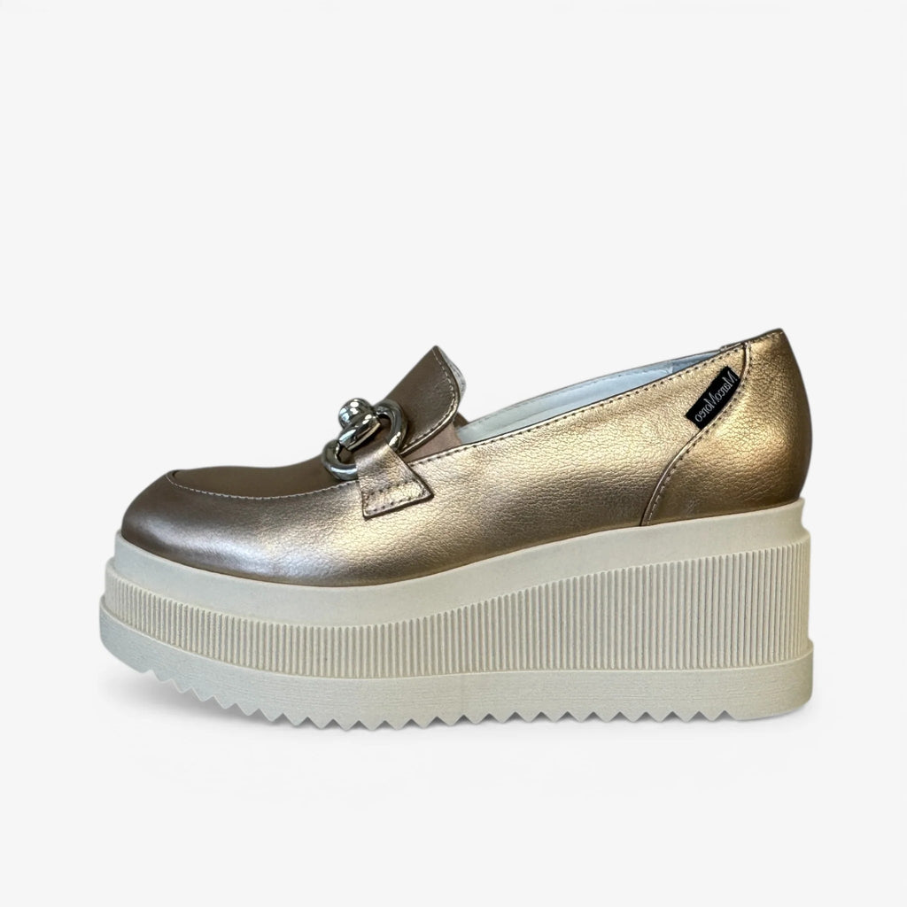 Gold platform shoe on a white background