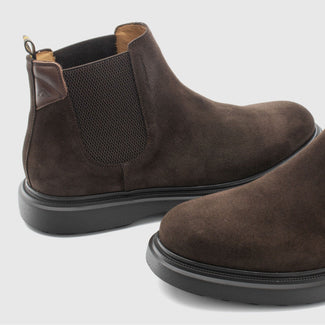 Brown suede Chelsea boot on a light gray background