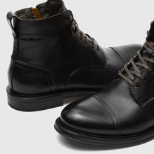 Load image into Gallery viewer, Pair of black leather boots on a light gray background
