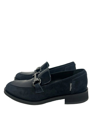 A pair of dark navy blue loafers with a mix of suede and patent leather panels, featuring a decorative silver-tone horsebit detail across the vamp, set against a plain white background.