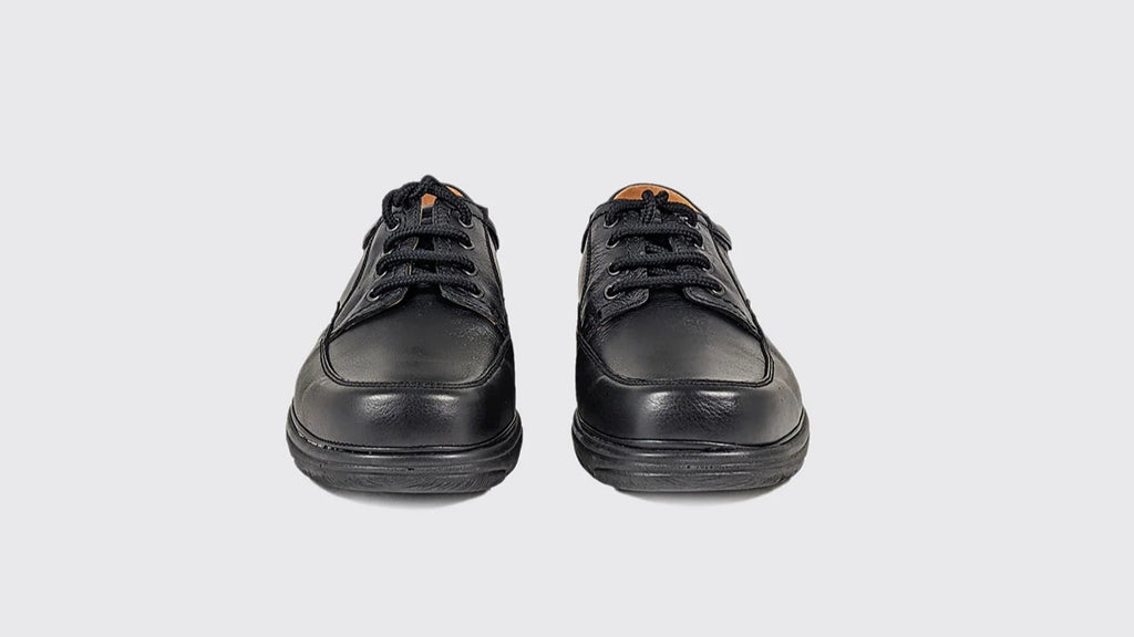 Pair of black leather shoes on a white background