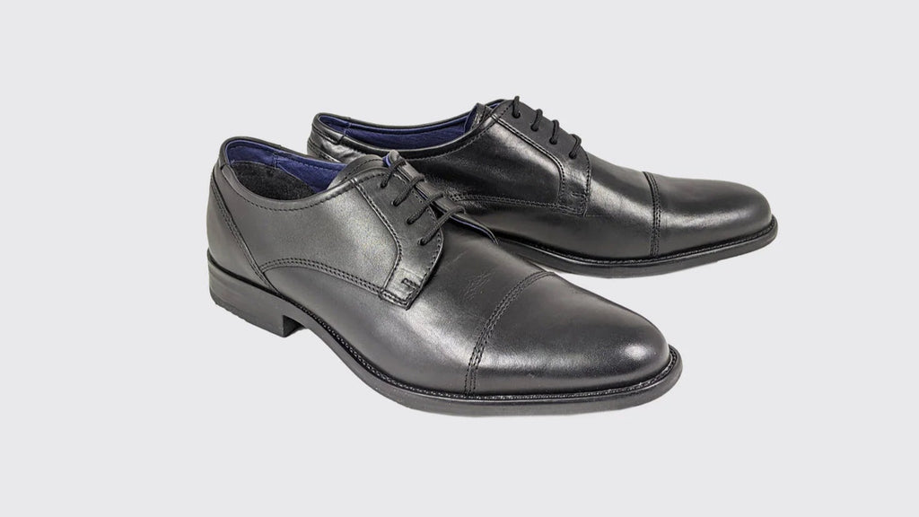 Pair of gray dress shoes on a light gray background