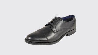 Black leather dress shoe on a light gray background