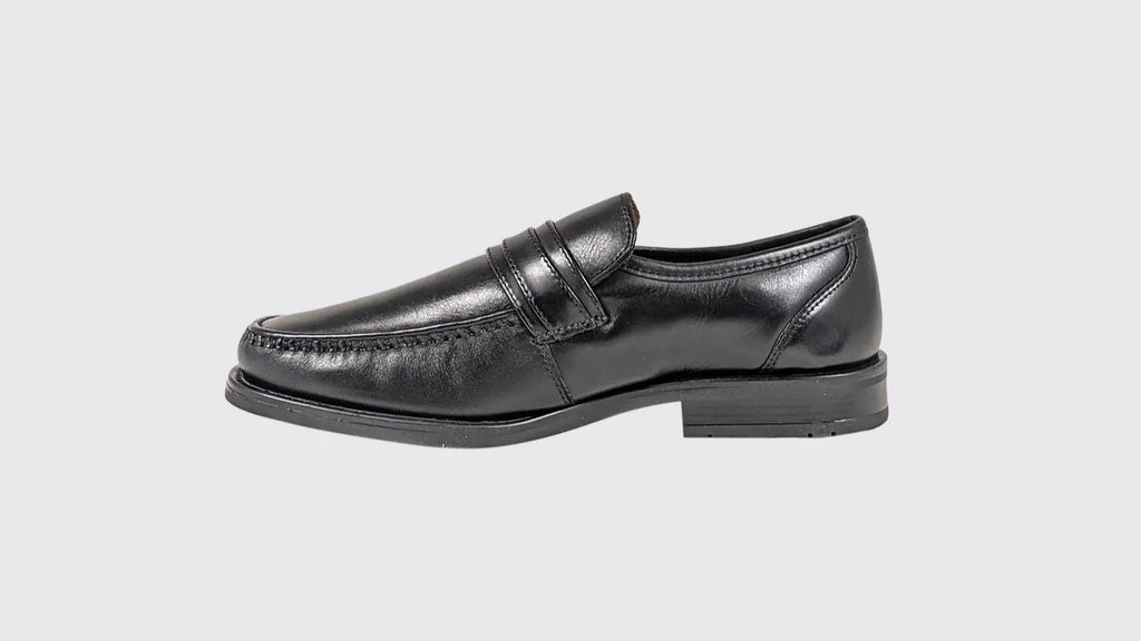 Black leather loafers on a light gray background