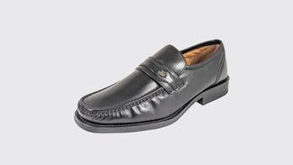 Black leather loafer shoe on a light gray background