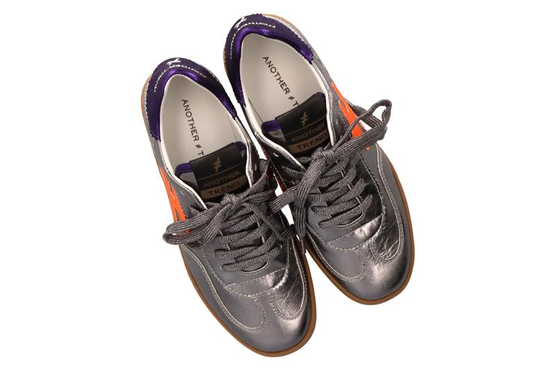 Pair of gray sneakers with orange accents on a white background