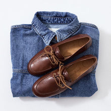 Load image into Gallery viewer, Brown loafers on a folded denim shirt with a white background
