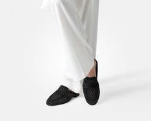 Load image into Gallery viewer, Black woven slippers worn with white pants on a white background
