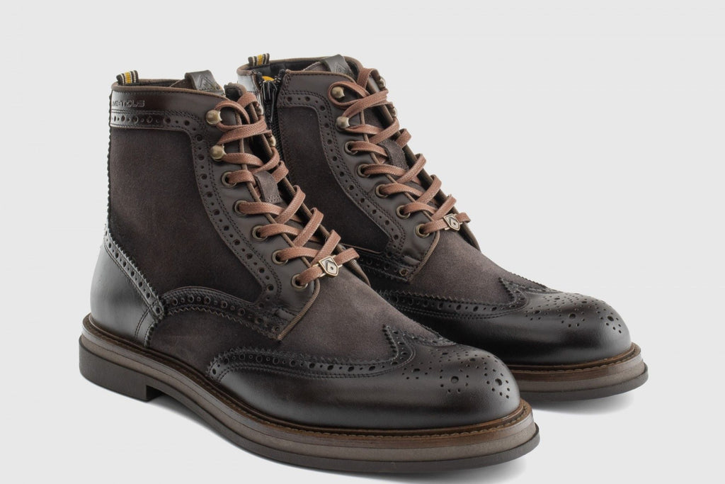 Pair of brown leather boots with lace-up design on a light gray background