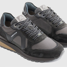 Load image into Gallery viewer, Pair of gray and black sneakers with brand logo on a light gray background
