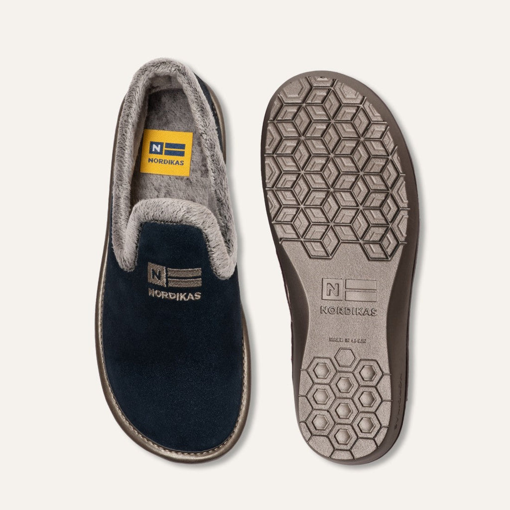 Gray and black slipper with Nordingas branding on a light gray background