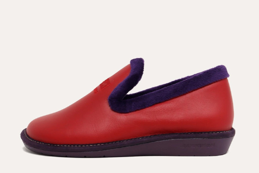 Red slip-on shoe with purple lining on a white background